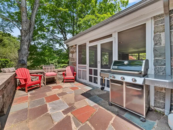 a backyard of a house with yard table and chairs