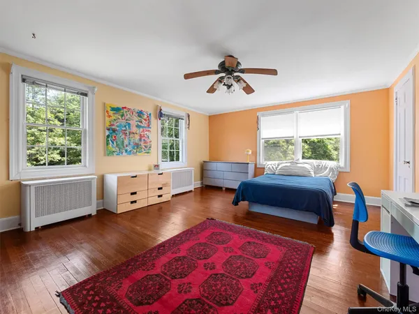 a bedroom with furniture and a window