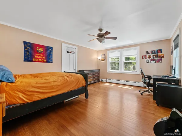 a bedroom with a bed dresser and a window