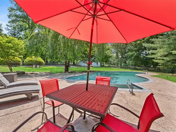 a view of outdoor sitting area with furniture and a yard