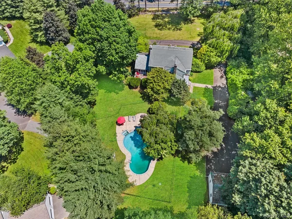 an aerial view of a house with a yard and lake view