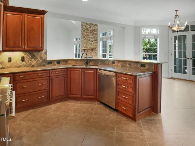 a kitchen with stainless steel appliances granite countertop a stove and a sink