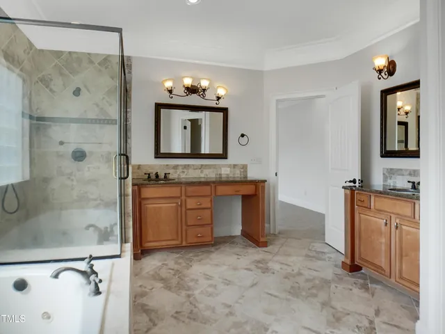 a bathroom with a granite countertop sink a mirror and a bathtub