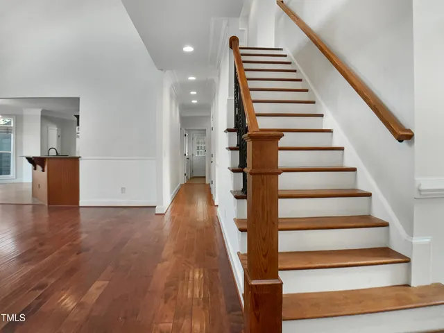 a view of entryway and hall with wooden floor