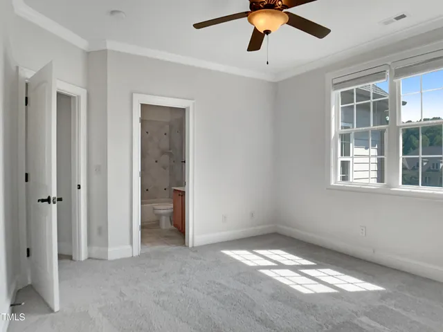 a view of empty room with ceiling fan