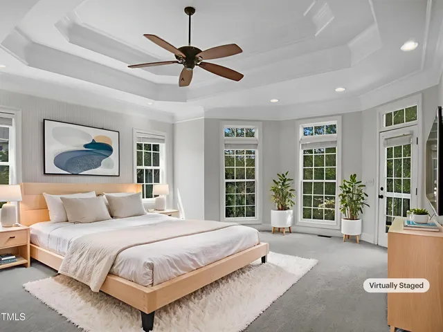 a spacious bedroom with a large bed and a window