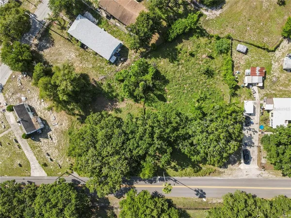 an aerial view of a house with yard