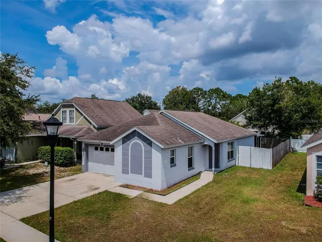 a aerial view of a house next to a yard