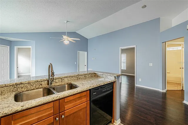 a kitchen with a sink and a granite counter top