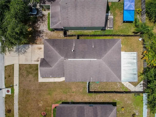 an aerial view of a house with a yard