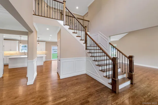 a view of entryway and hall with wooden floor