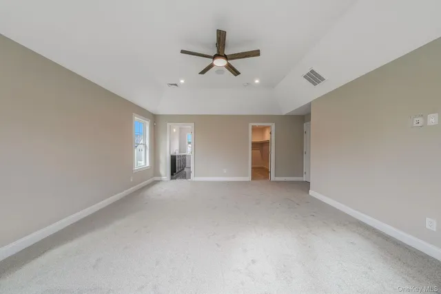 a view of a livingroom with a ceiling fan and window