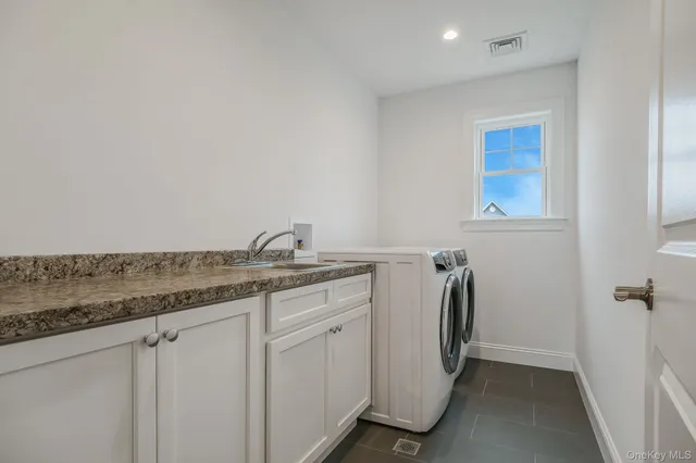 a utility room with a sink a washer and dryer