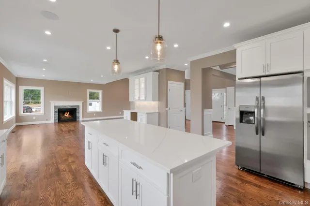 a large kitchen with sink a refrigerator and a refrigerator