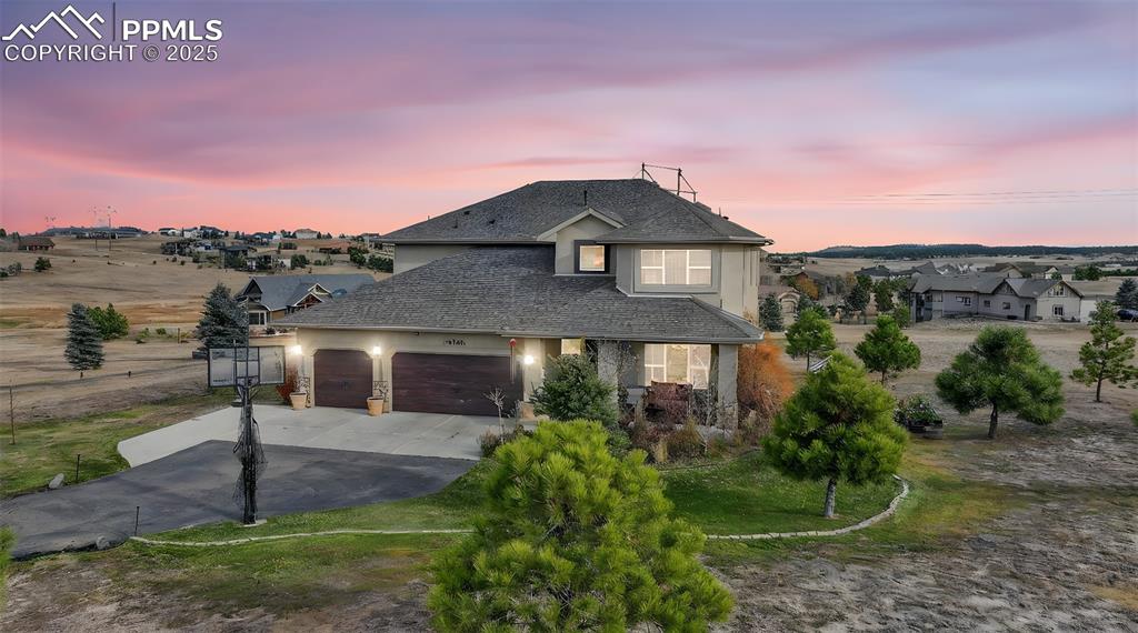 19125 Baskerville Way Monument, CO 80132 - Photo 1 of 39 a front view of a house with a yard