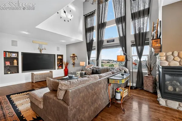 a living room with fireplace furniture and a flat screen tv