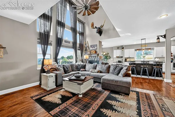 a living room with furniture fireplace and a table