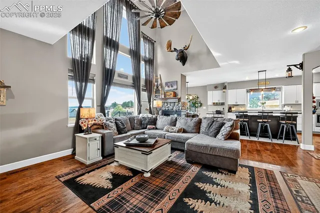 a living room with furniture fireplace and a table
