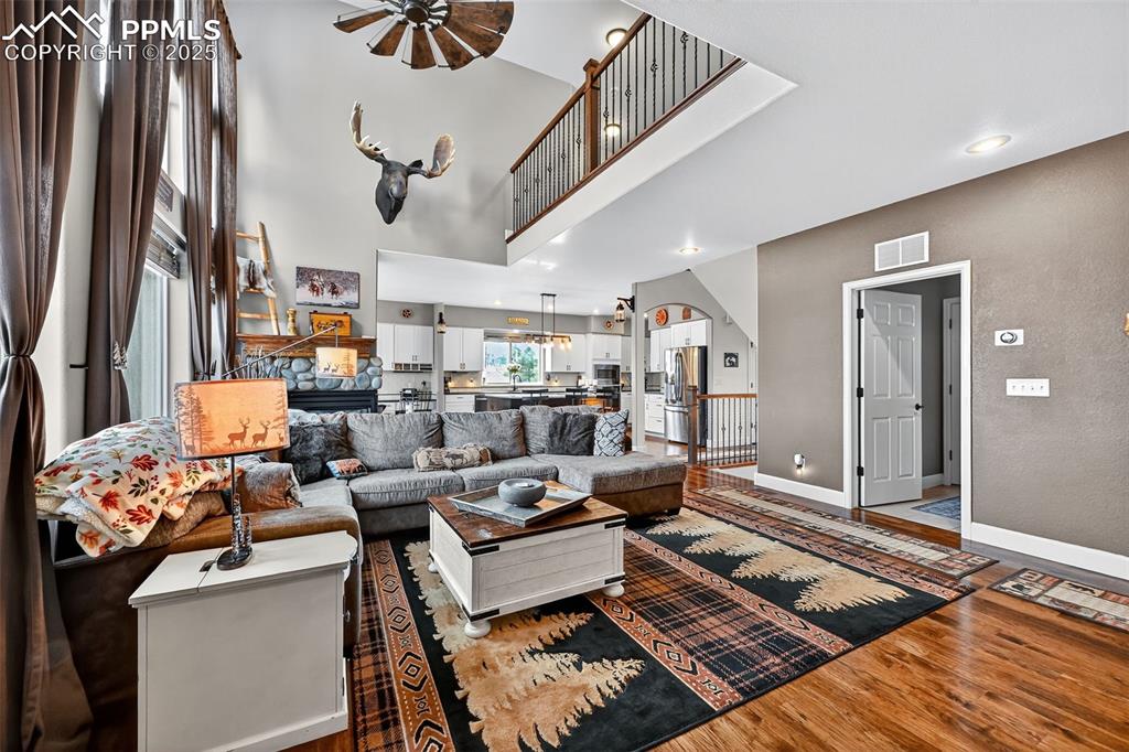 19125 Baskerville Way Monument, CO 80132 - Photo 14 of 39 a living room with lots of furniture and a rug