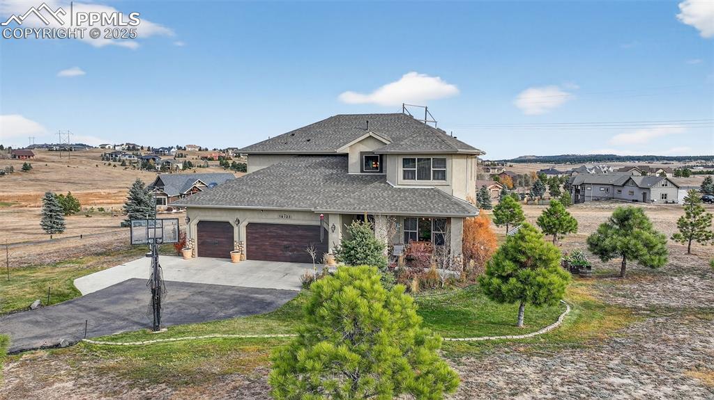 19125 Baskerville Way Monument, CO 80132 - Photo 2 of 39 a front view of a house with garden
