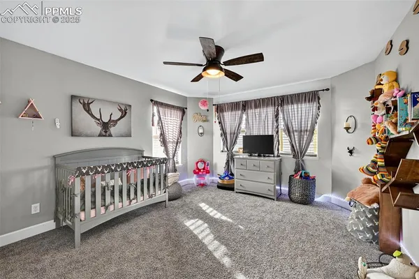 a bedroom with furniture and a flat screen tv
