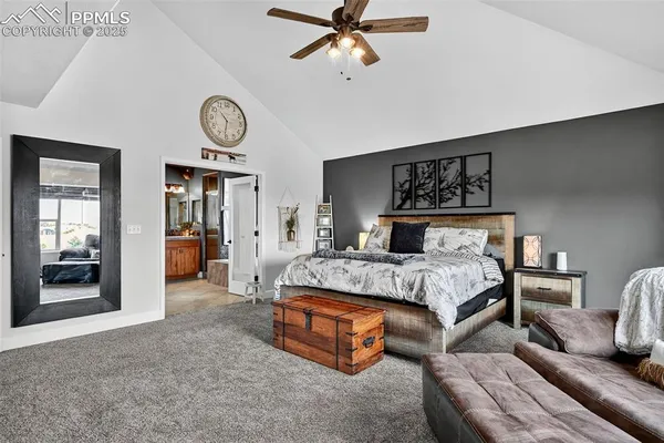 a bedroom with a bed and a walk in closet with wooden floor