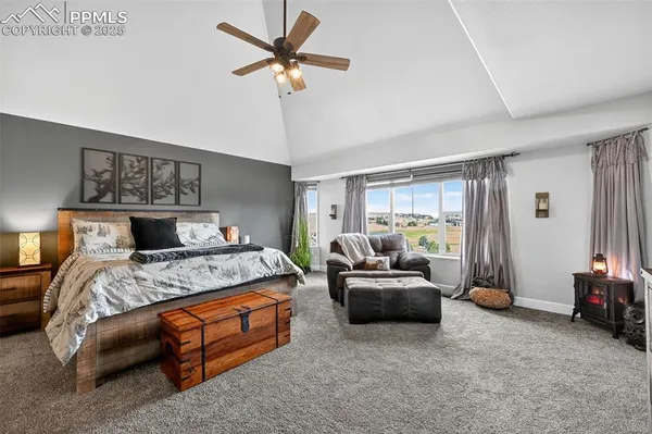 a bedroom with a bed couch and a window