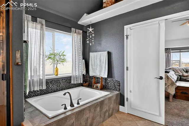 a bathroom with a tub and a shower