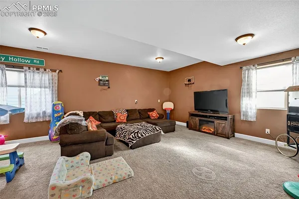 a bedroom with furniture and a flat screen tv