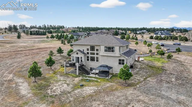an aerial view of a house with a yard and lake view