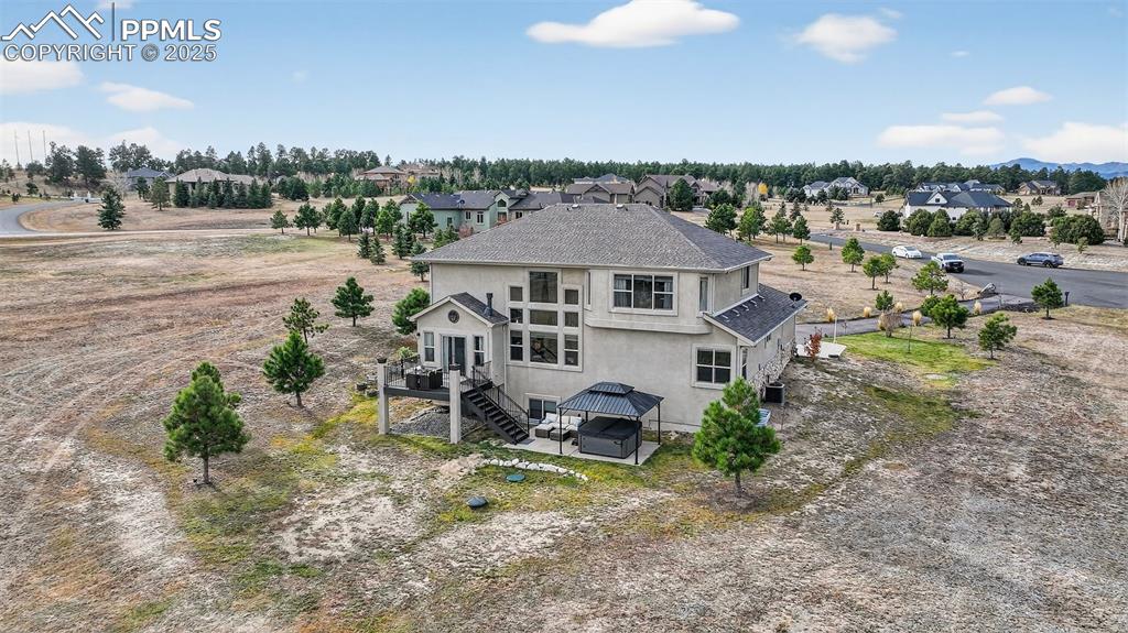 19125 Baskerville Way Monument, CO 80132 - Photo 38 of 39 an aerial view of a house with a yard and lake view