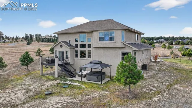 a view of a house with yard and sitting area