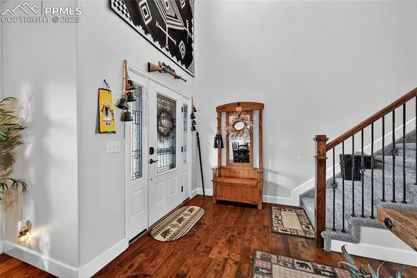 a very nice looking room with a white bed and wooden floor