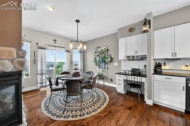 a living room with furniture a dining table and a fireplace