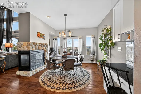 a living room with furniture a fireplace and a chandelier