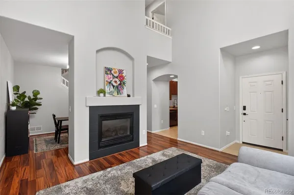 a living room with furniture and a fireplace
