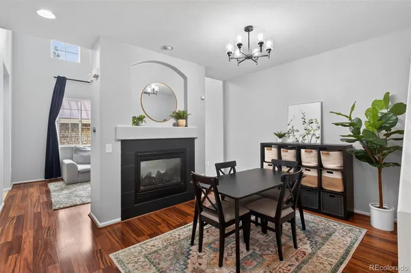 a view of a dining room with furniture and a fireplace