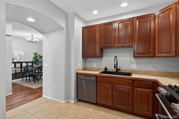 a kitchen with stainless steel appliances granite countertop a sink stove and cabinets