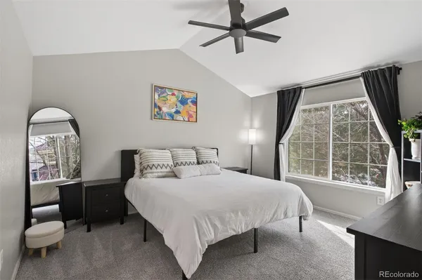 a bedroom with a large bed and a window