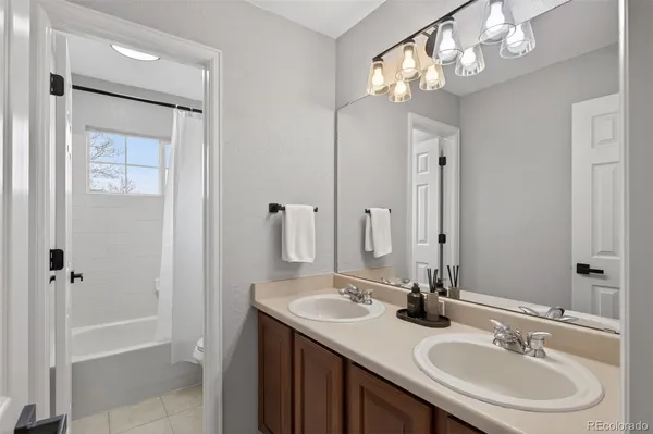 a bathroom with a sink double vanity and a mirror