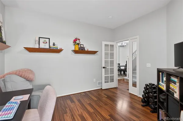 a living room with furniture and a wooden floor