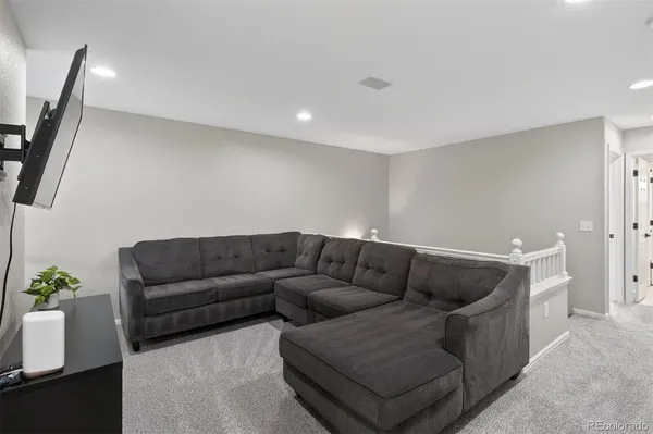 a living room with furniture and a rug