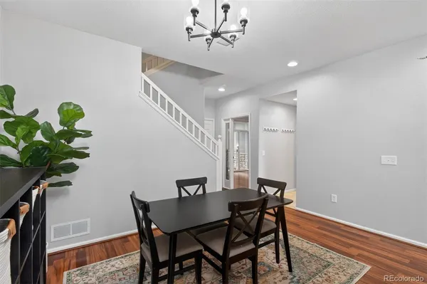 a view of a dining room with furniture and wooden floor