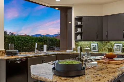 a bedroom with a bed couch and a large window