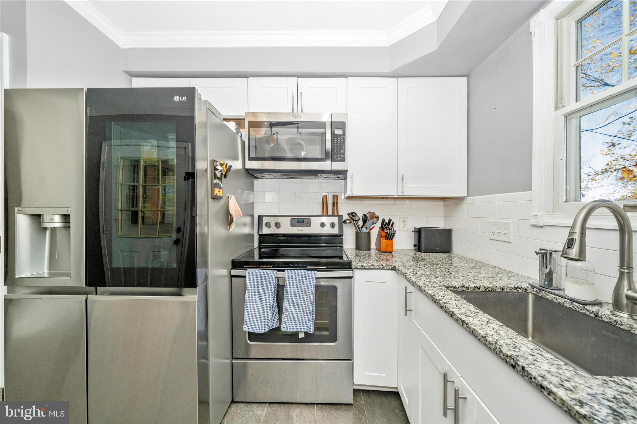 313 North Market Street Frederick, MD 21701 - Photo 14 of 40 a kitchen with stainless steel appliances granite countertop a refrigerator and a stove