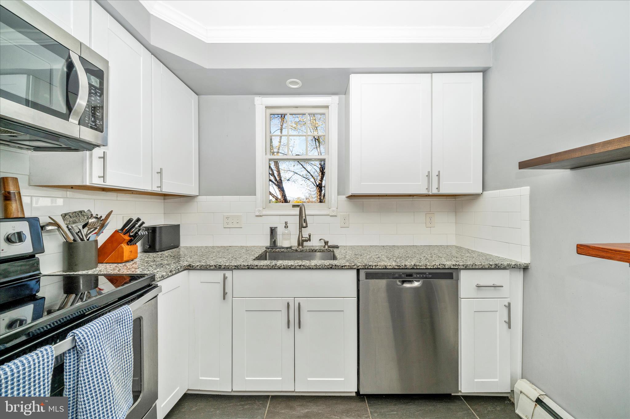 313 North Market Street Frederick, MD 21701 - Photo 15 of 40 a kitchen with granite countertop cabinets stainless steel appliances and a sink