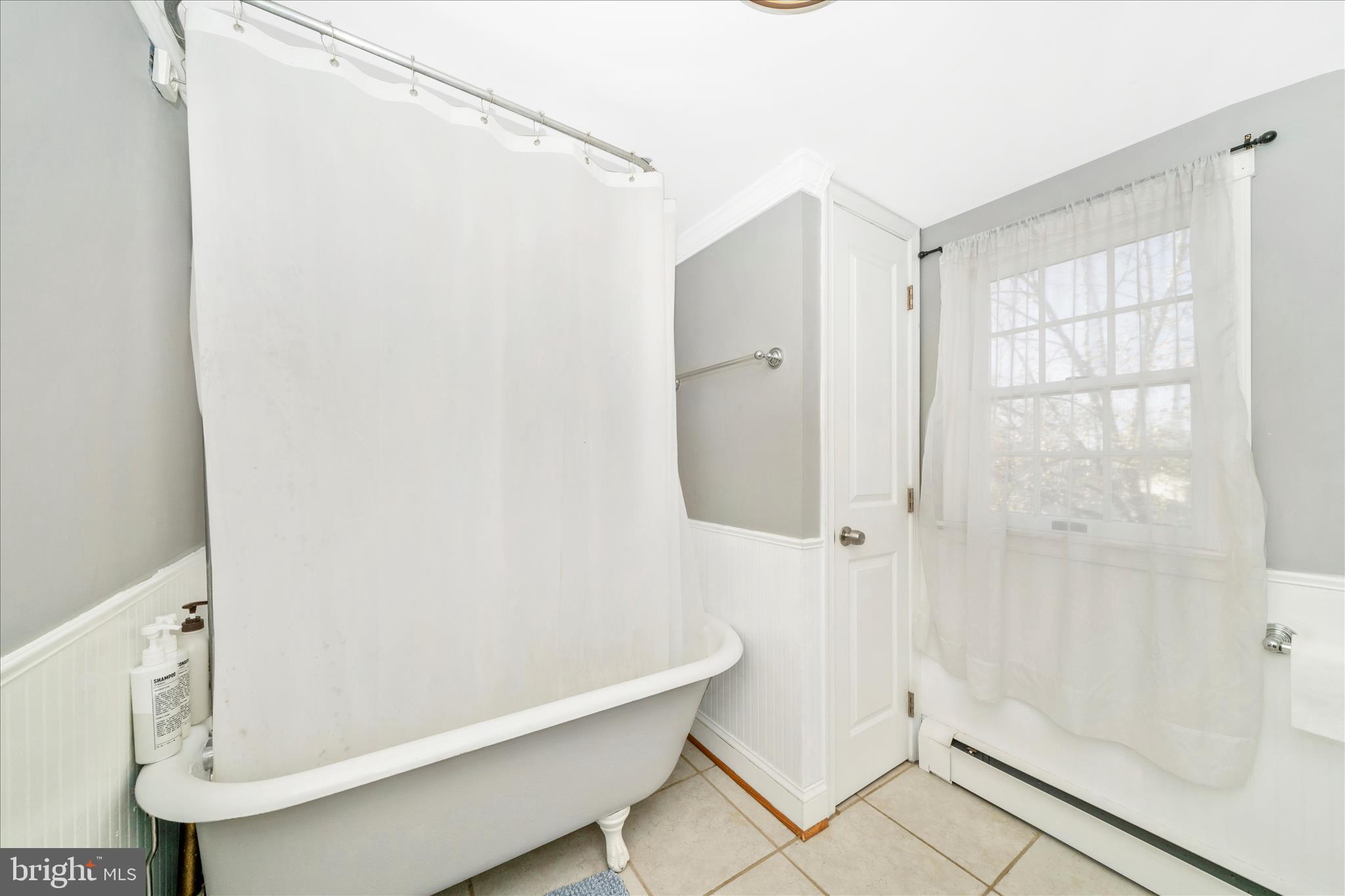 313 North Market Street Frederick, MD 21701 - Photo 26 of 40 a bathroom with a bathtub and a shower