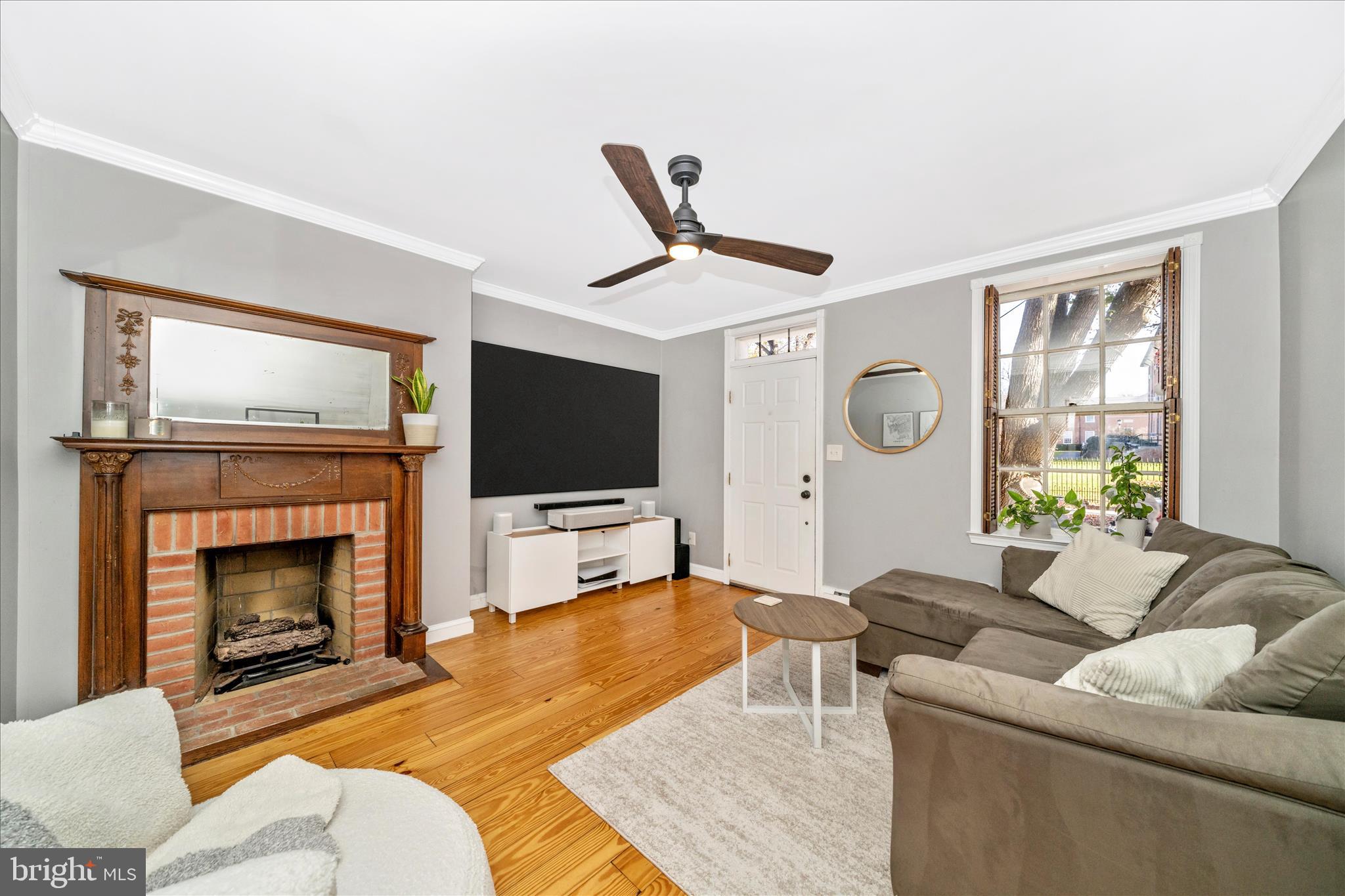 313 North Market Street Frederick, MD 21701 - Photo 4 of 40 a living room with furniture a flat screen tv and a fireplace