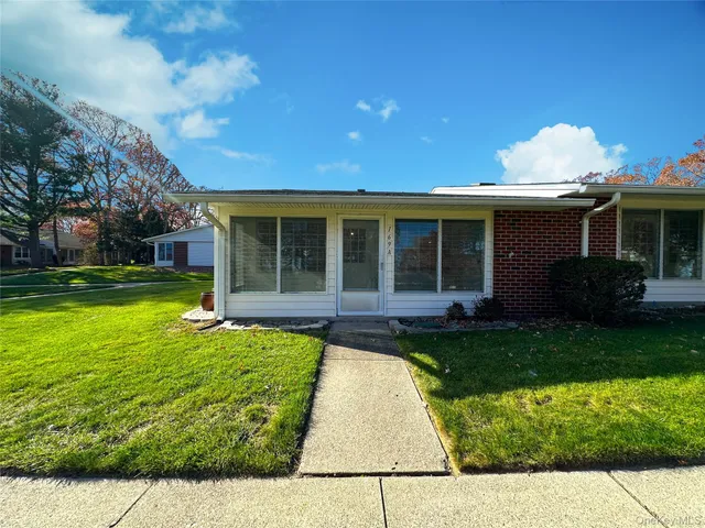 a view of a house with a swimming pool and a yard