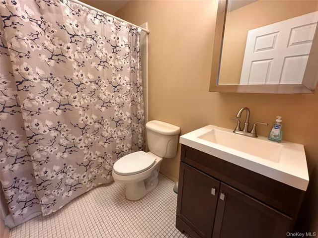 a bathroom with a sink toilet and a mirror
